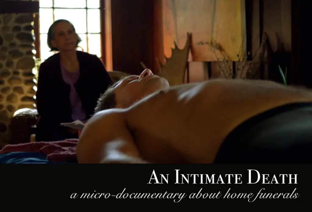 Title card for a macro-documentary on home funerals called An Intimate Death, an older woman in backlit against light from a window, a main is laid out for a funeral in front of her.